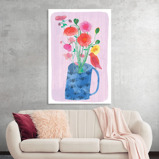 “Bright Poppies in Vase” by Fiona Solley is a captivating artwork that breathes life and vibrancy into any space. The print, characterized by its bold and lively poppies, set against a serene pink backdrop, encapsulates the essence of spring and renewal. Each flower is rendered with meticulous detail, showcasing a harmonious blend of warm hues that dance elegantly off the canvas. The blue vase adorned with subtle leaf motifs anchors the composition, adding depth and contrast. 