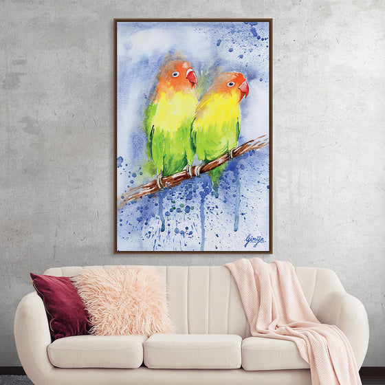 Lovebirds by Girija Kulkarni is a vibrant watercolor painting that captures the tenderness and affection between two small birds. The birds, painted in shades of green, yellow, and orange, are perched side by side on a branch, their beaks touching. The artist's skillful use of color and light creates a sense of warmth and intimacy, while the delicate details of the birds' feathers and the surrounding landscape add to the overall charm of the piece. 