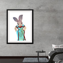  Dive into the whimsical world of Ava Leopold with “Ava Qipao,”a captivating artwork that marries traditional elegance and playful imagination.  In this piece, a graceful rabbit adorned in a beautifully detailed Qipao, an emblematic Chinese dress, stands against an ethereal backdrop, inviting viewers into a narrative woven with cultural richness and fantastical allure. 