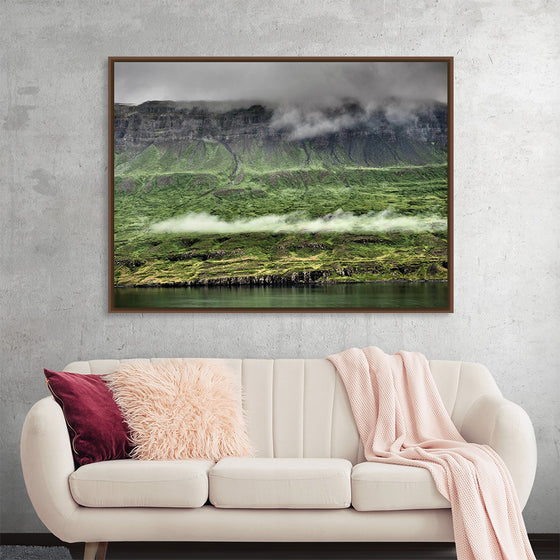 Dive into the captivating world of “Iceland with Clouds 4” by Julie Ellitt. This exquisite print captures the enigmatic dance of misty clouds weaving through Iceland’s rugged terrains, evoking a sense of mystique and untouched beauty. Every detail, from the lush greenery to the imposing cliffs, is rendered with impeccable clarity, inviting viewers into a world where nature’s majesty reigns supreme. 