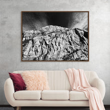  This captivating print captures the majestic dance between a rugged mountain and the dramatic sky, offering an intimate journey into the awe-inspiring embrace of nature’s silent symphony. 