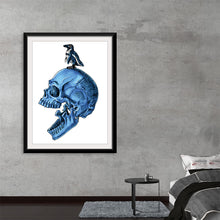  “Penguin” by Marta Tesoro invites you to a mesmerizing dance between mortality and imagination. Within this high-quality print, a meticulously detailed blue skull emerges, its hollow eyes and silent mouth whispering secrets of existence. 