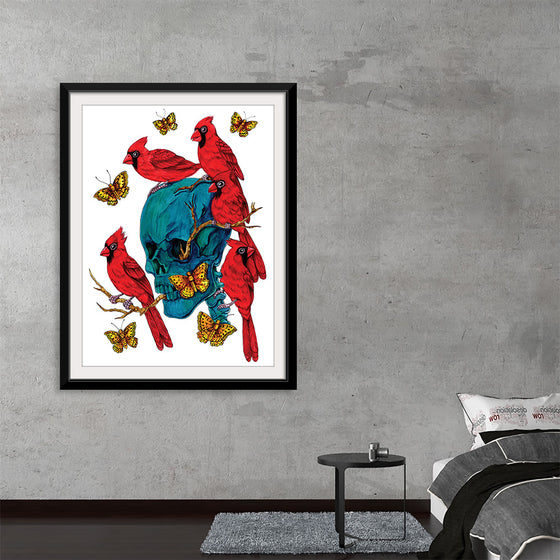 This artwork is a captivating dance of life and death, masterfully captured in a print. At the heart of the piece is a hauntingly beautiful turquoise skull, brought to life by vibrant red cardinals and golden butterflies. The intricate details of the wing patterns and the branches emerging from the skull create a mystical aura that draws the viewer in. 