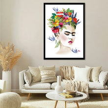  Bring the vibrant spirit of Frida Kahlo into your home with "She is Frida" by Mercedes Lopez Charro. This captivating watercolor print reimagines the iconic artist with a modern twist, adorning her head with a colorful floral crown and featuring playful swallows fluttering around her. The artwork's bold colors and expressive lines capture Kahlo's unique personality and artistic vision. This piece is perfect for adding a touch of inspiration and individuality to any space.