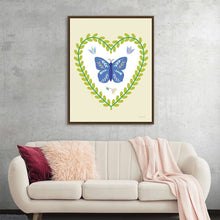  "Time to Bloom IV Vertical" by Mercedes Lopez Charro is a delicate and enchanting piece that celebrates the beauty of nature. A vibrant blue butterfly takes center stage within a heart-shaped frame of lush greenery, surrounded by delicate wildflowers and butterflies.