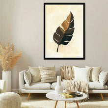  “Tropical Leaf II” by Yvette St. Amant invites you to a serene oasis of botanical elegance. This exquisite print captures the essence of simplicity and natural beauty. A meticulously painted leaf, its hues of brown gracefully contrasting against a soft, creamy background, becomes a visual poem. 
